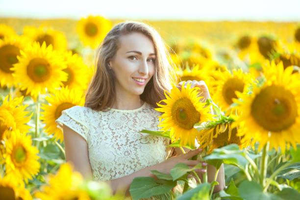 istock Lovely woman in a field of sunflowers. 846684708