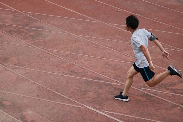 istock Athletic Asian runner sprinter crossing the finish line. 846685542