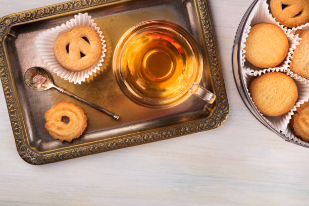 istock Danish butter cookies and tea on vintage tray with copyspace 846689074