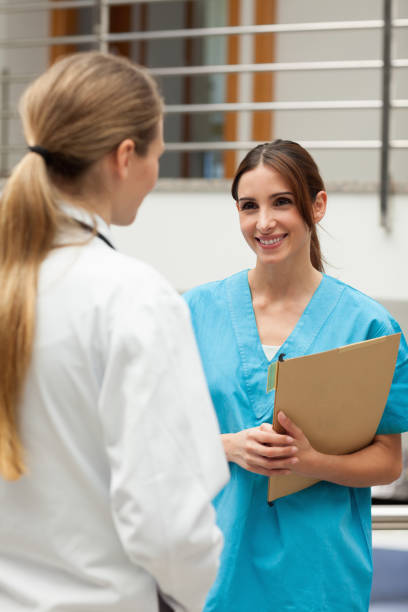 istock Smiling nurse talking to a doctor 846692718