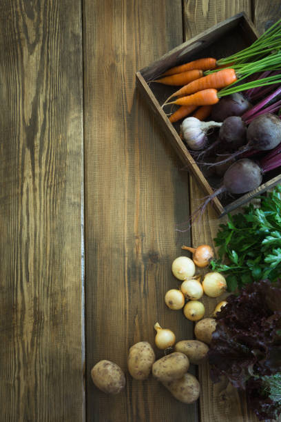 istock Harvest fresh vegetables from carrot, beetroot, onion, garlic on old wooden board. Top view, rustic style. Autumn still life. Gardening. Copy space. 846693216