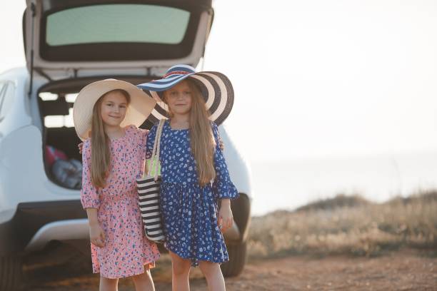 istock Two little girls prepare to travel by car 846693708