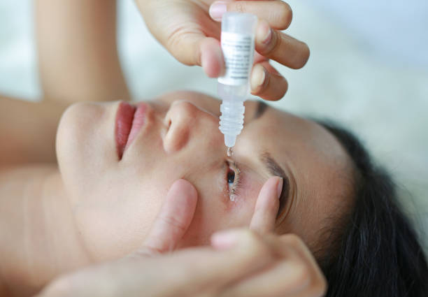 istock Closeup view of woman applying eye drop. 846696132