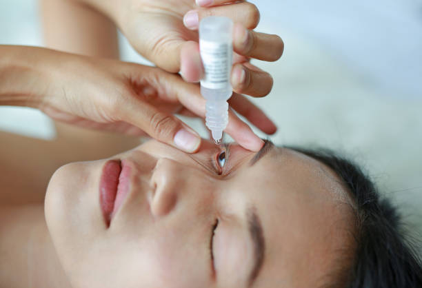 istock woman dripping eye with eyes drops. 846696212