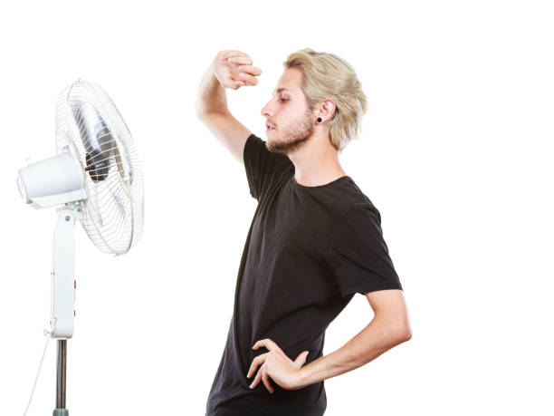 istock Young man in front of cooling fan 846697052
