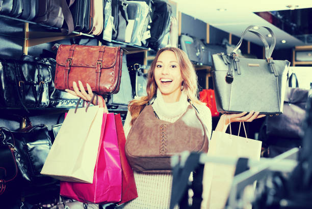istock Young woman customer selecting new hand bag 846700222