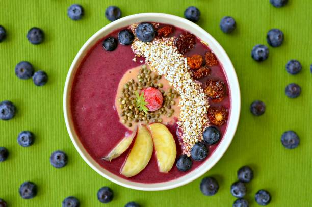 Blueberry, apple and cranberry smoothie bowl with toppings