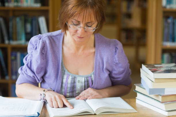 istock Mature female student studying at desk in the library 846707270