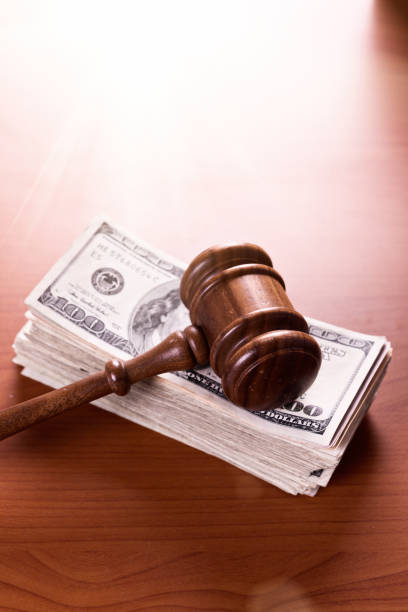 istock Judge's gavel on large stack of $100 American banknotes 846711042