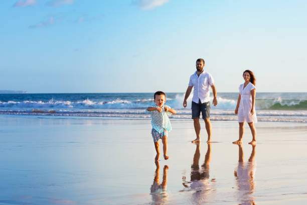 istock Happy family have fun on sunset beach 846711176