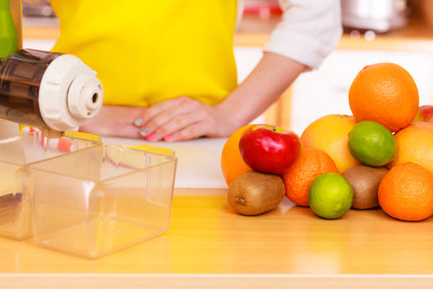 istock Woman in kitchen preparing fruits for juicing 846717818