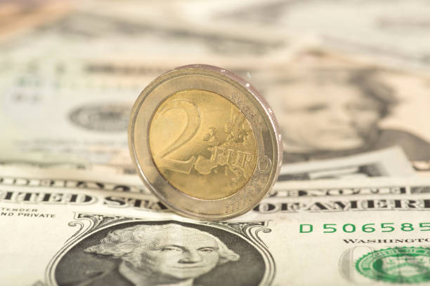 istock One euro coin and dollar banknotes 846718444