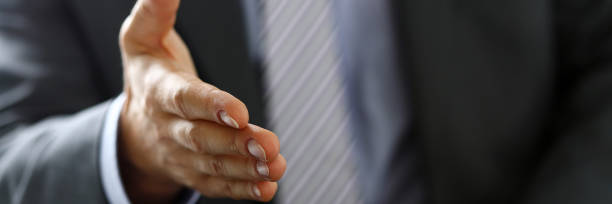 istock Man in suit and tie give hand as hello in office 846719574