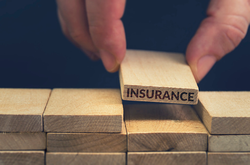 Insurance word written on wood block