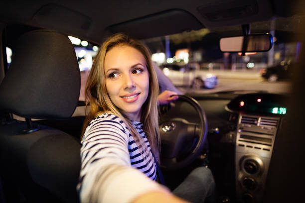 istock Beautiful young woman driving her car at night. 846722848