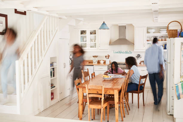 Interior Of Busy Family Home With Blurred Figures Interior Of Busy Family Home With Blurred Figures working hard stock pictures, royalty-free photos & images