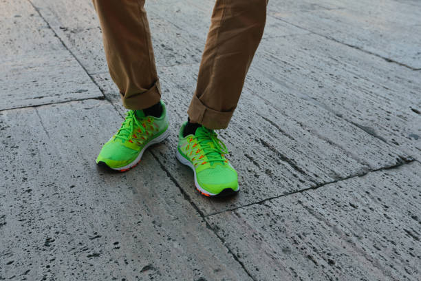 istock Man legs in socks and green sneakers 846728100