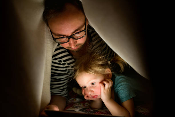 istock Father with tablet and little daughter at home at night. 846730886