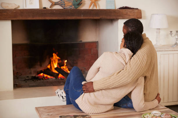 istock Romantic Couple Relaxing In Lounge Next To Open Fire 846734972