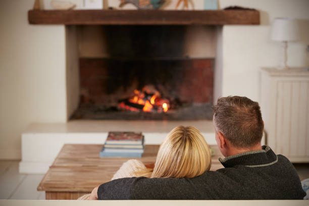 istock Romantic Couple Relaxing In Lounge Next To Open Fire 846735932