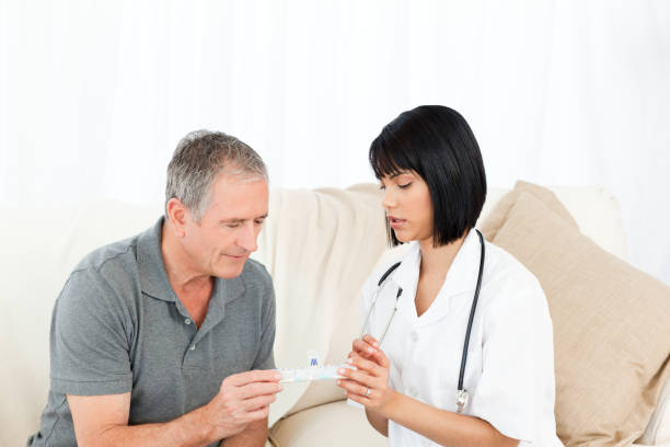 istock Nurse showing pills to her patient 846736314