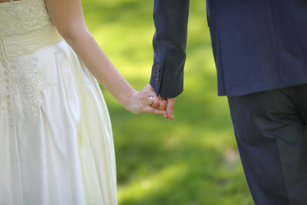 istock Bride and groom holding hands 846738560
