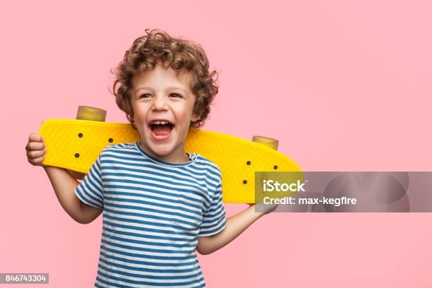 Cheerful Boy With Yellow Longboard Stock Photo - Download Image Now - Child, Boys, Portrait