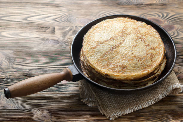 istock Stack of pancakes on a cast-iron frying pan. Flat lay 846745740