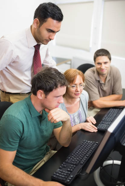 istock Teacher and mature students in computer room 846749428