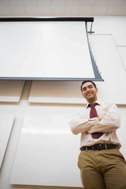 istock Elegant teacher with projection screen in the lecture hall 846750202