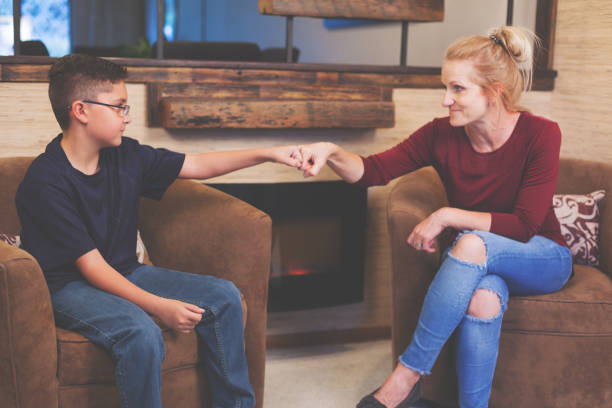 Foster Care Woman and Boy Child Talking Foster Care Woman and Boy Child Talking inside a retro home eyecrave stock pictures, royalty-free photos & images
