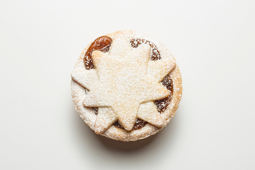 Mince Pie dusted with icing sugar against a white background
