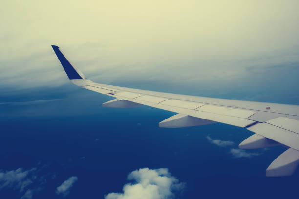 istock wing plane with a background of clouds and sea 846762384