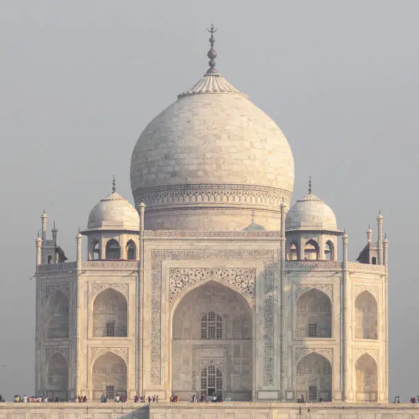 Amazing view on the Taj Mahal in sunset light with reflection in water. The Taj Mahal is an ivory-white marble mausoleum on the south bank of the Yamuna river. Agra, Uttar Pradesh, India.