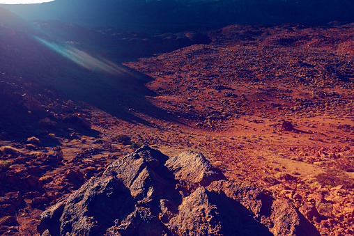 the morning sunrise and sunbeams over volcanic arid area in Tenerife.