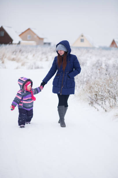 istock Happy mother walking with baby at winter 846767326