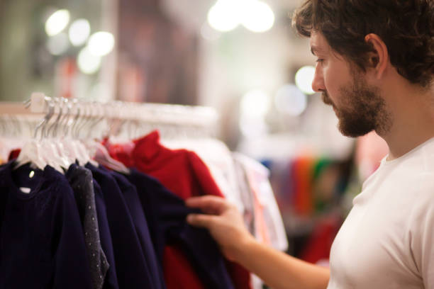 istock Attractive young man choosing baby clothes 846767522