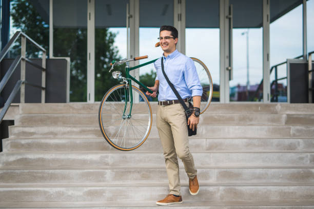 istock Young businessman carying his bicycle up stairs 846770840