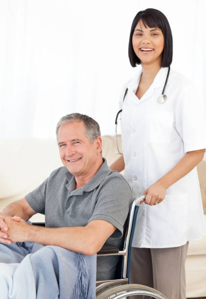 istock Nurse with her patient looking at the camera 846771024