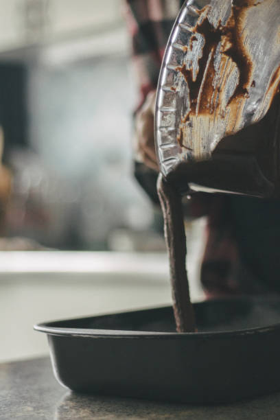 Putting a brownie mixing on a baking sheet