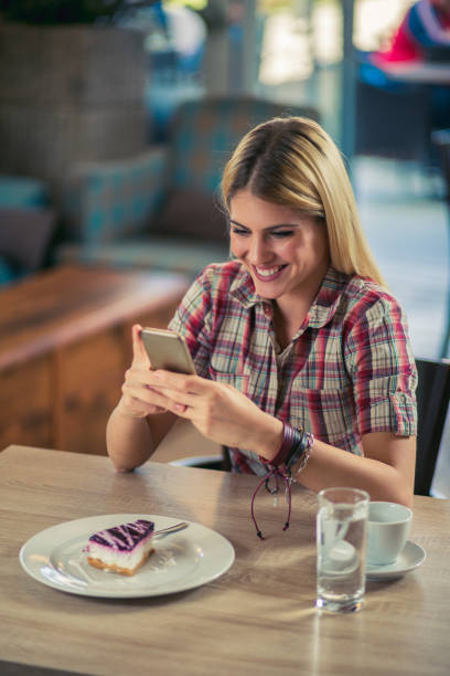 istock Attractive young woman using mobile phone in modern cafe 846771100