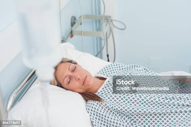 Female Patient Lying On A Bed With Closed Eyes Stock Photo - Download Image Now - Bed - Furniture, Blond Hair, Hospital