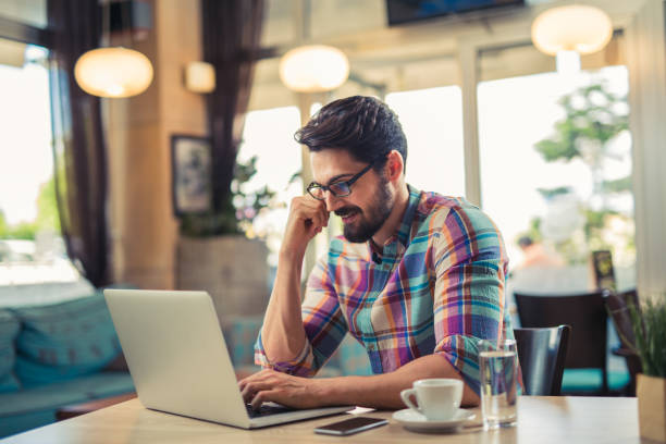 istock Young  casual man using laptop in modern cafe 846774064