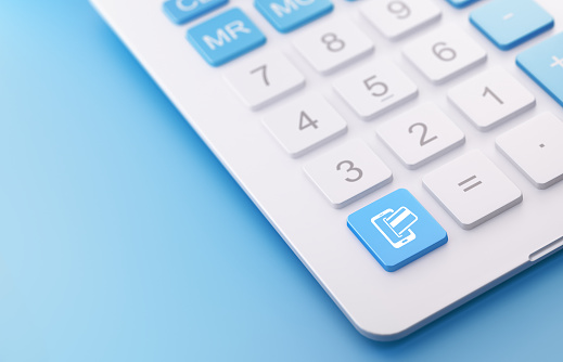 Modern calculator with online shopping button on a blue background. Online shopping button has an icon on it. Online shopping Horizontal composition with copy space. Selective focus.
