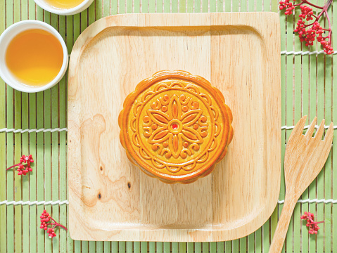 Mooncake on a wooden plate for Mid-Autumn Festival or Harvest Festival