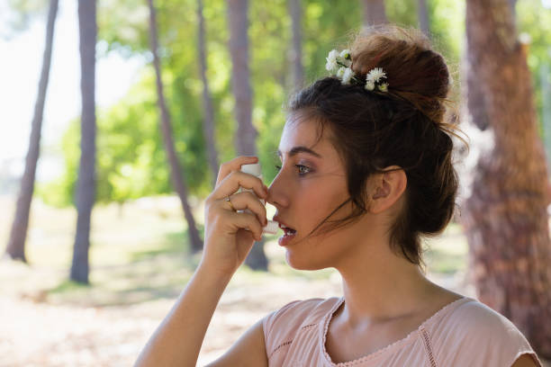 istock Woman using asthma inhaler in the park 846782096