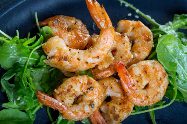 istock close up with fresh fried shirmps with arugula on a black plate 846782268