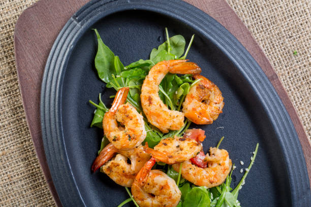 istock close up with fresh fried shirmps with arugula on a black plate 846782272