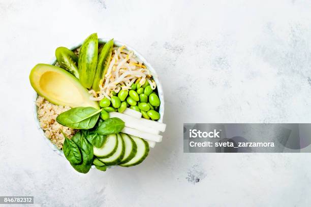 Vegan Detox Green Buddha Bowl Recipe With Quinoa Avocado Cucumber Spinach Tomatoes Mung Bean Sprouts Edamame Beans Daikon Radish Top View Flat Lay Copy Space Stock Photo - Download Image Now