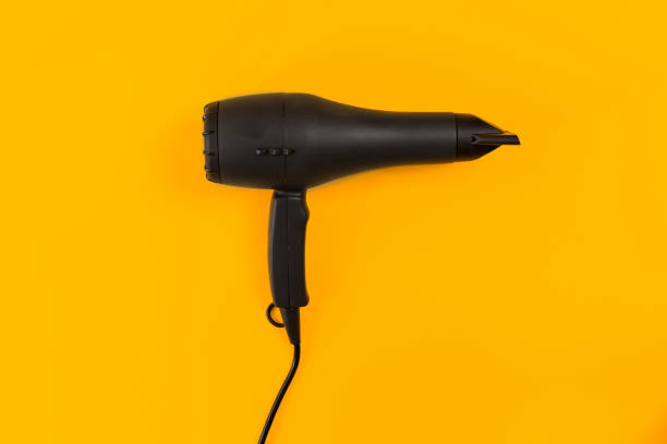 istock Black Hair dryer on orange background 846783374